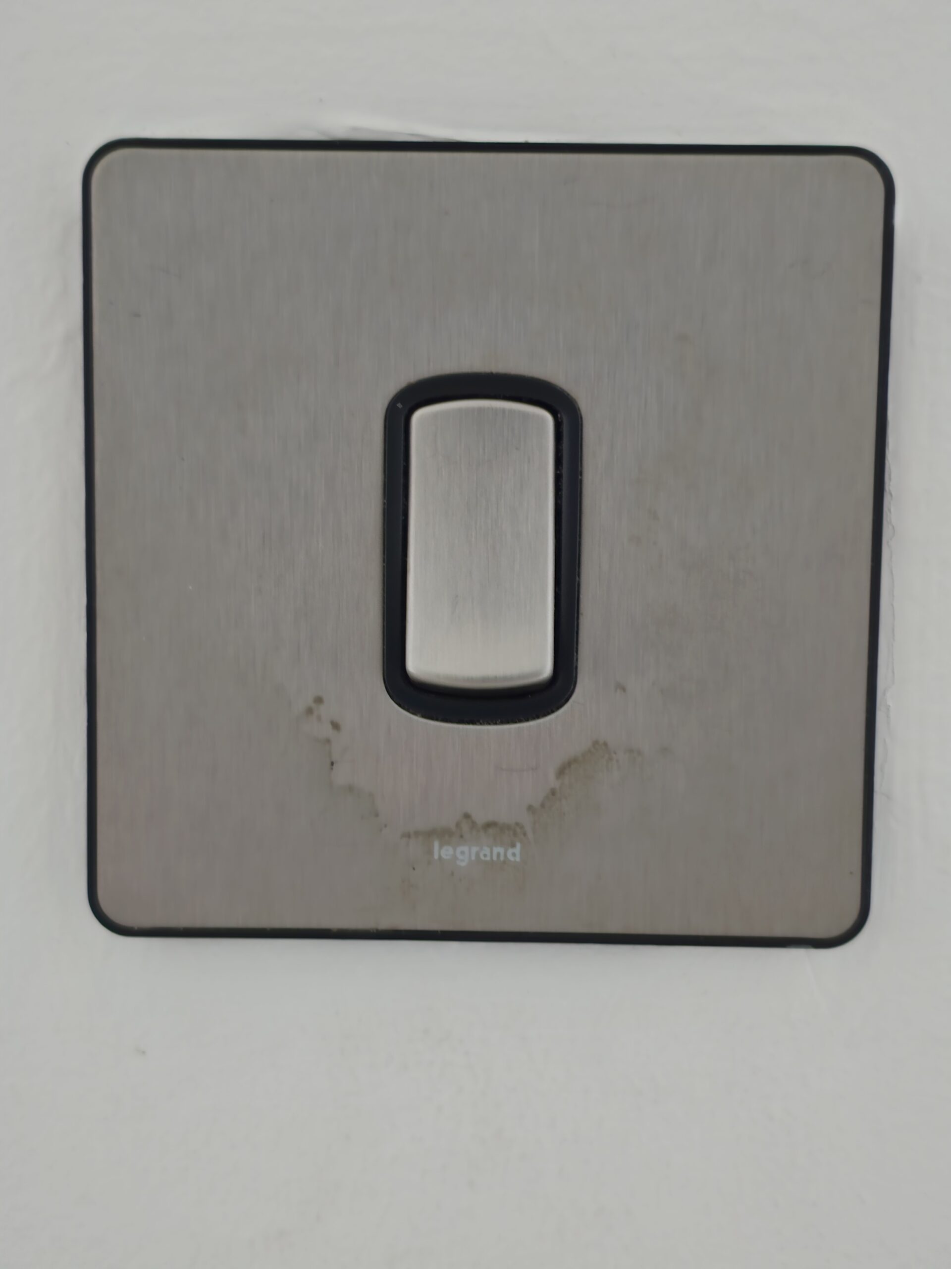 Hand grease on light switch area before cleaning — Multipurpose Cleaner test Dubai UAE